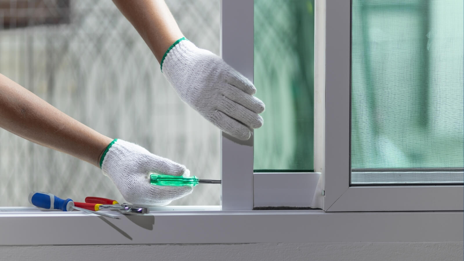 man repairing window