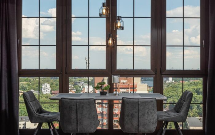 Luxury floor-to-ceiling window with a dining table, chairs, and a chandelier