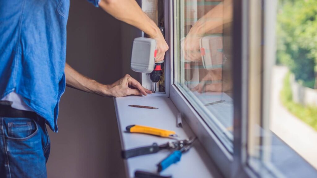 A man installing new windows