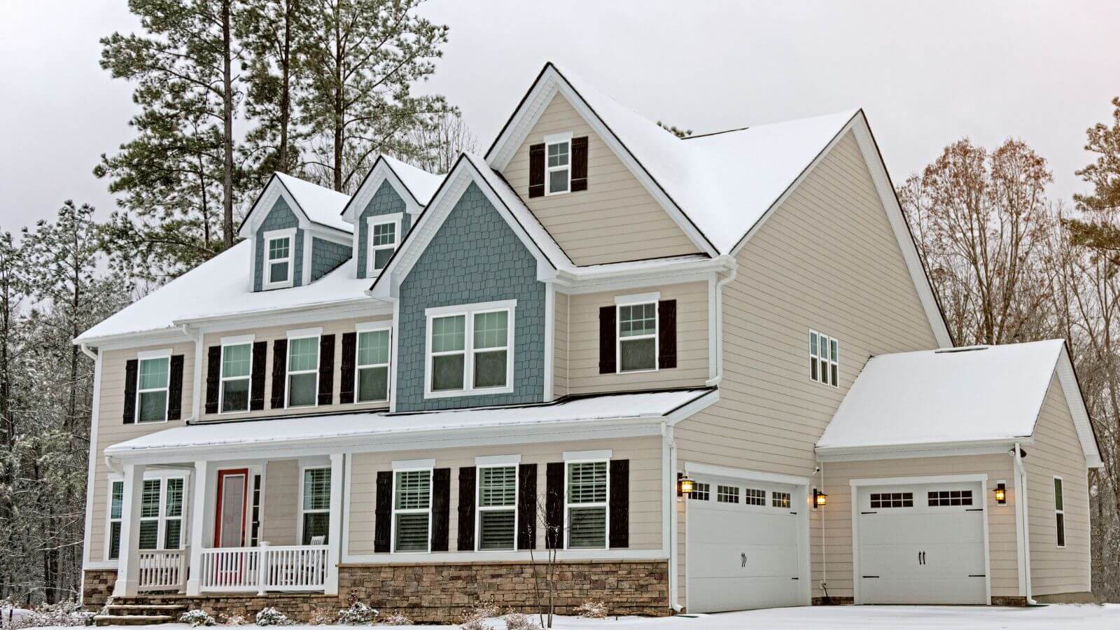 blue and cream house in snow